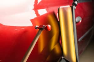 blending hammer on red car