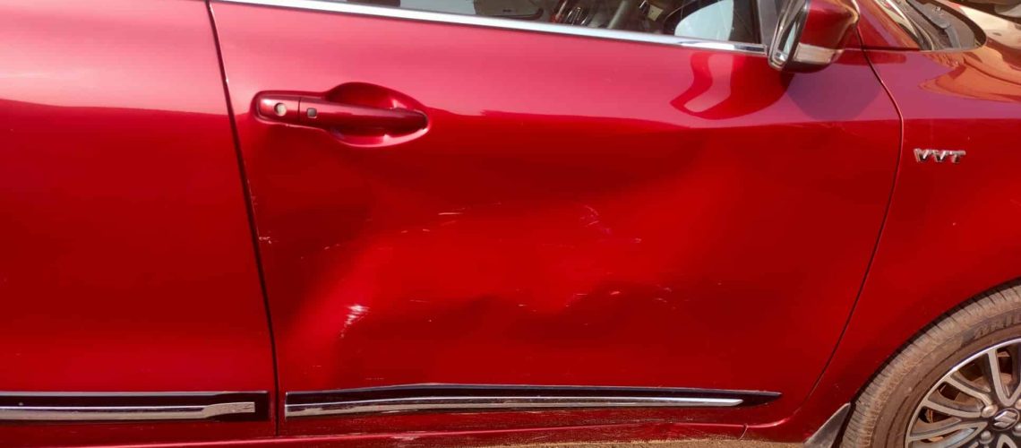 red car with door dent